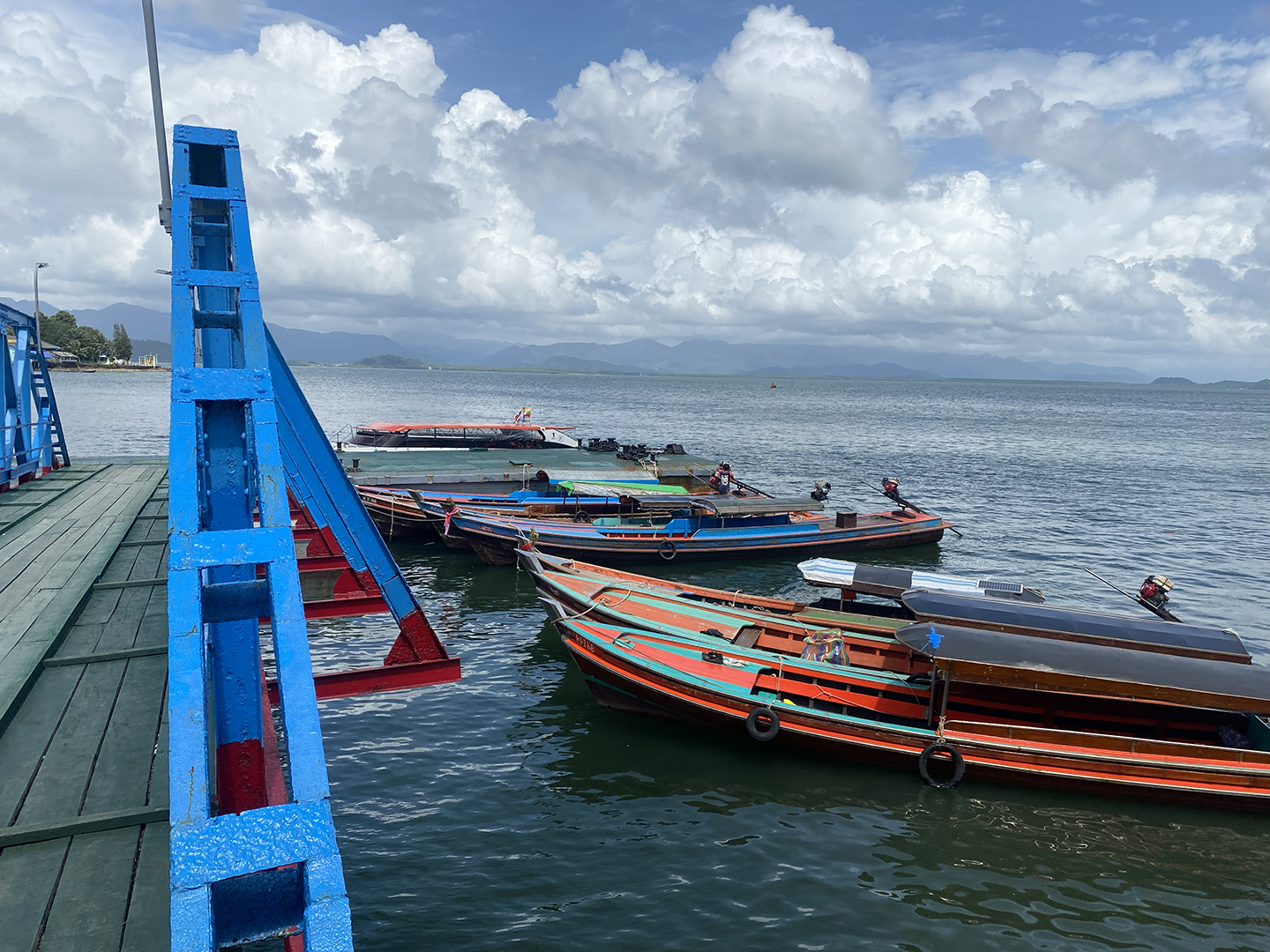 Boats waiting at dock to take travellers back into Thailand