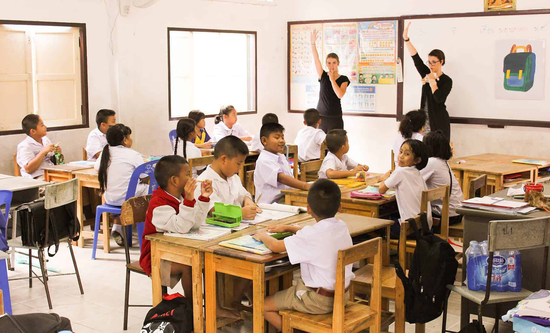 Stock image of a Thai classroom with 2 foreign teachers at the front